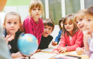 Children in classroom learning about the world