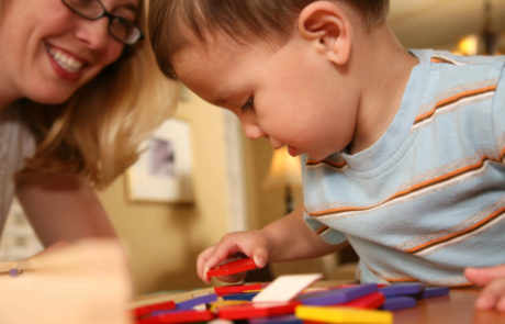 Infant playing with colored blocks