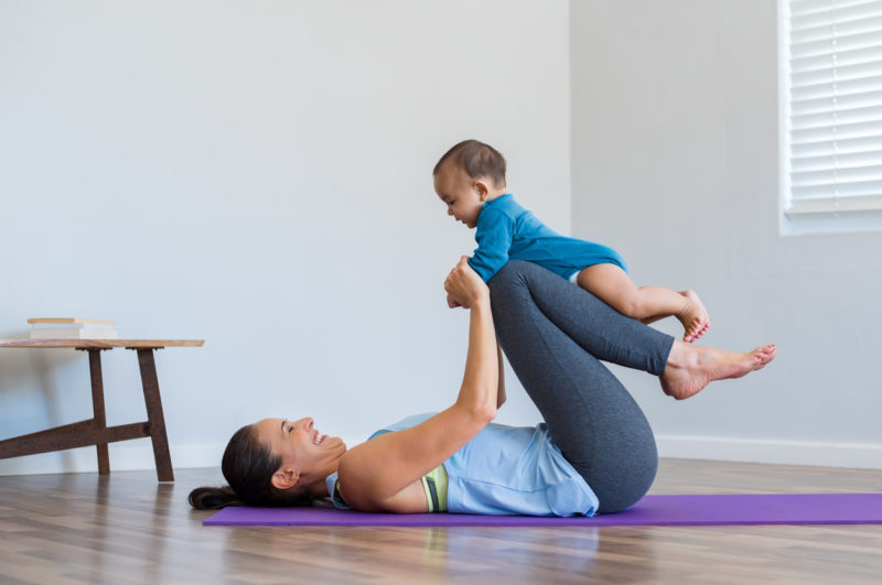 Mother and little son exercising Mommy and Child doing yoga pose